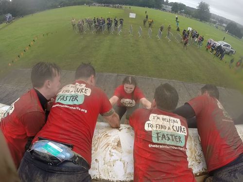 Go Pro photo from tough mudder - helping each other up over a muddy wall